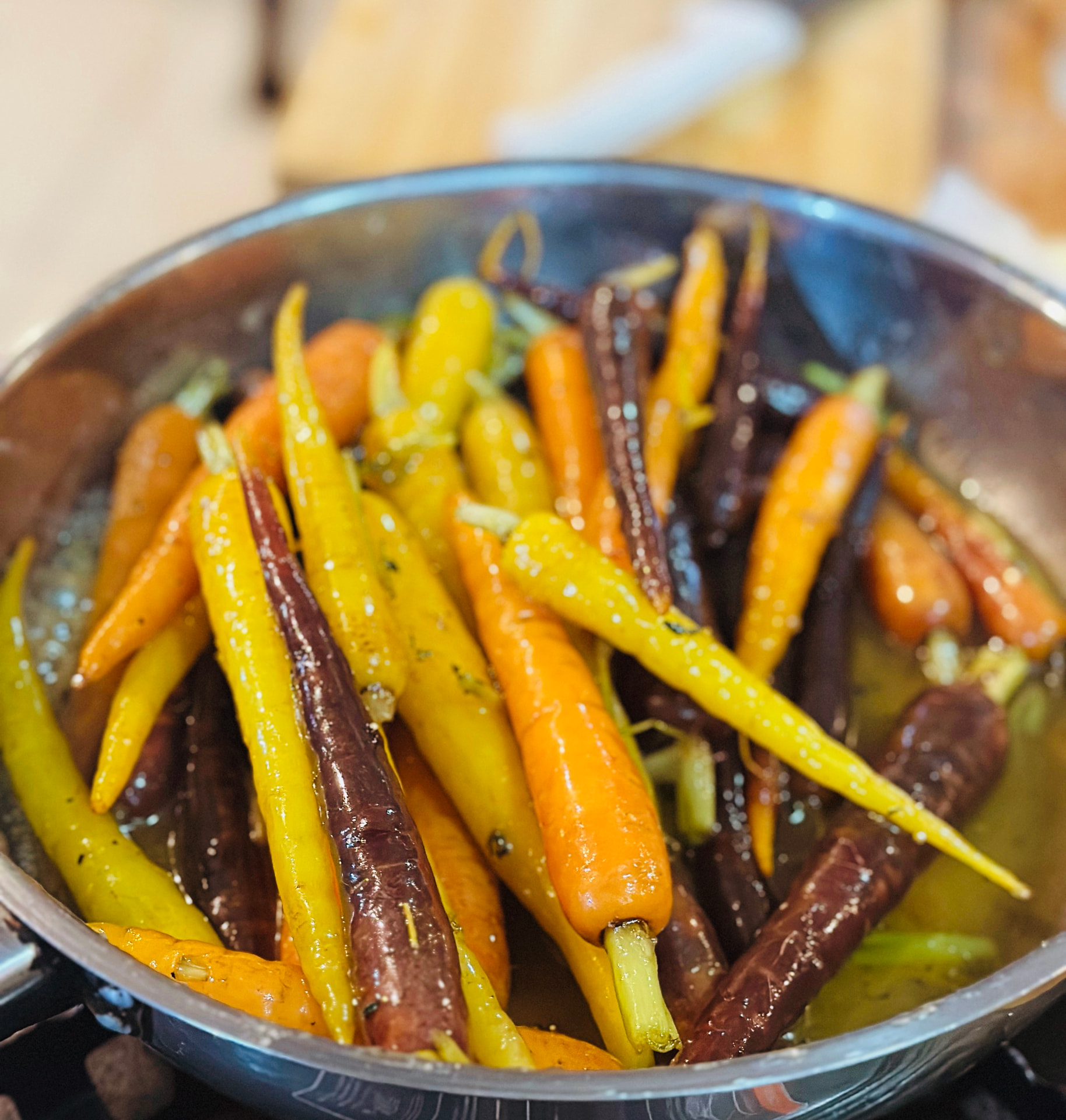 Rainbow heirloom carrots glazing in a pan